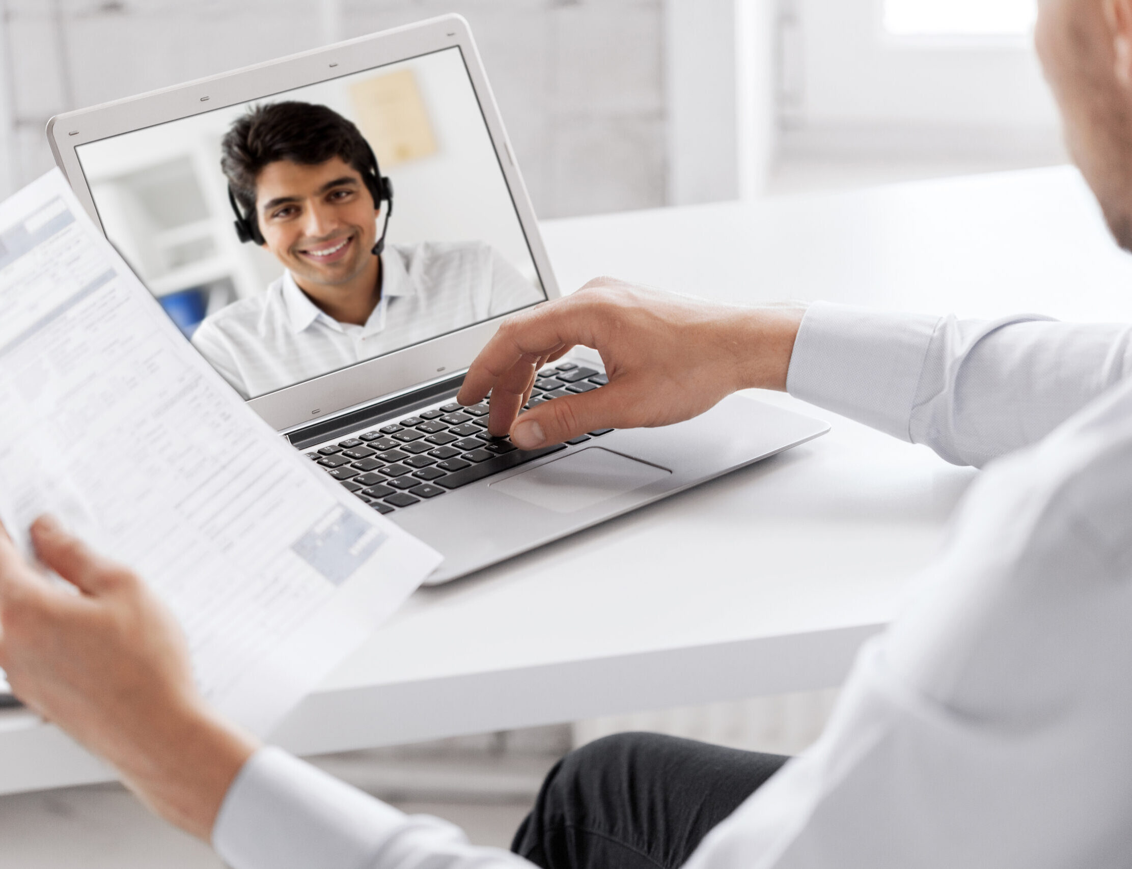 man in white shirt on a video call
